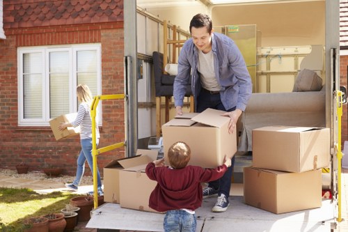 Furniture removal team arranging a sofa pick-up in a Harringay home