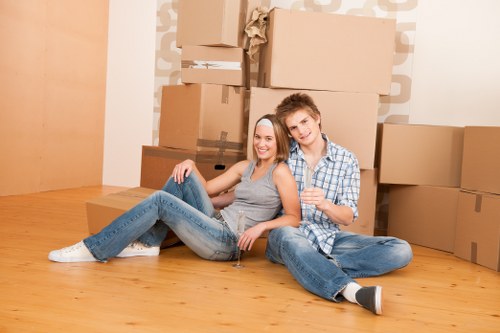Removal team using safe lifting methods during a house move