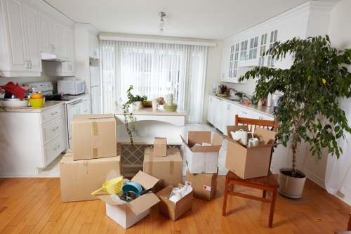 Removal crew carrying furniture through a residential property in Harringay